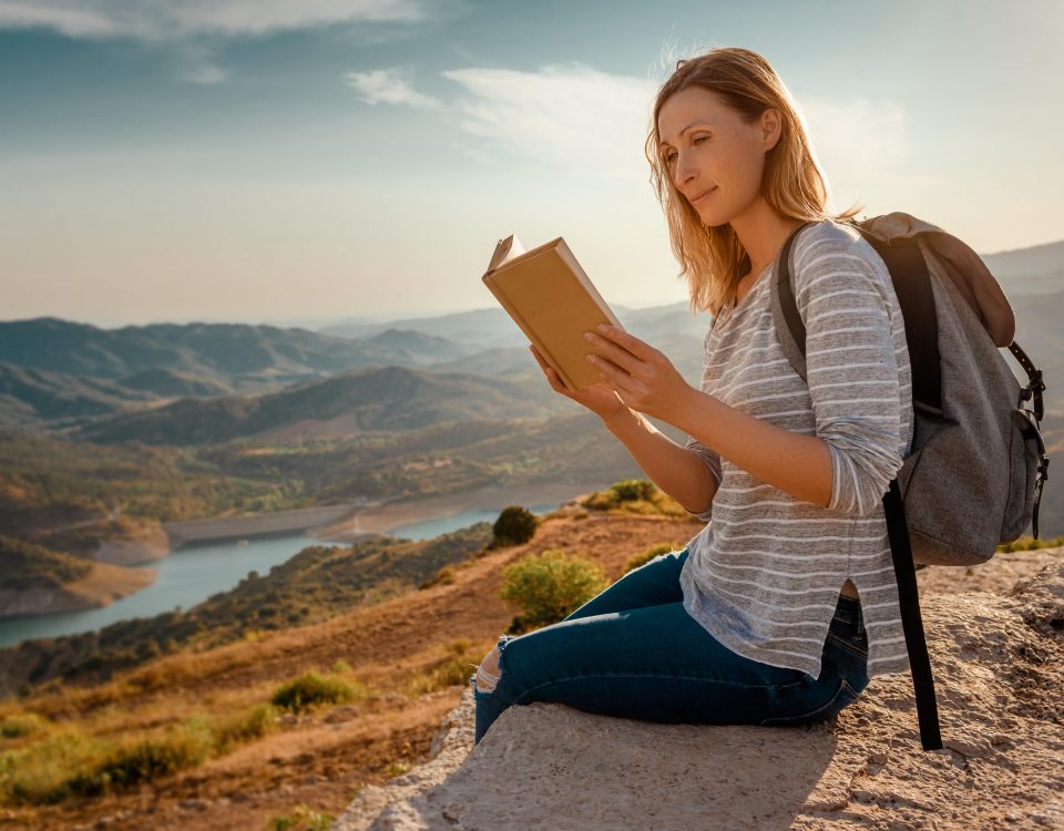 Woman reading book trip